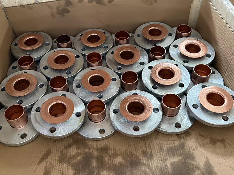 Composite copper nickel weld neck flange with carbon steel backing flange